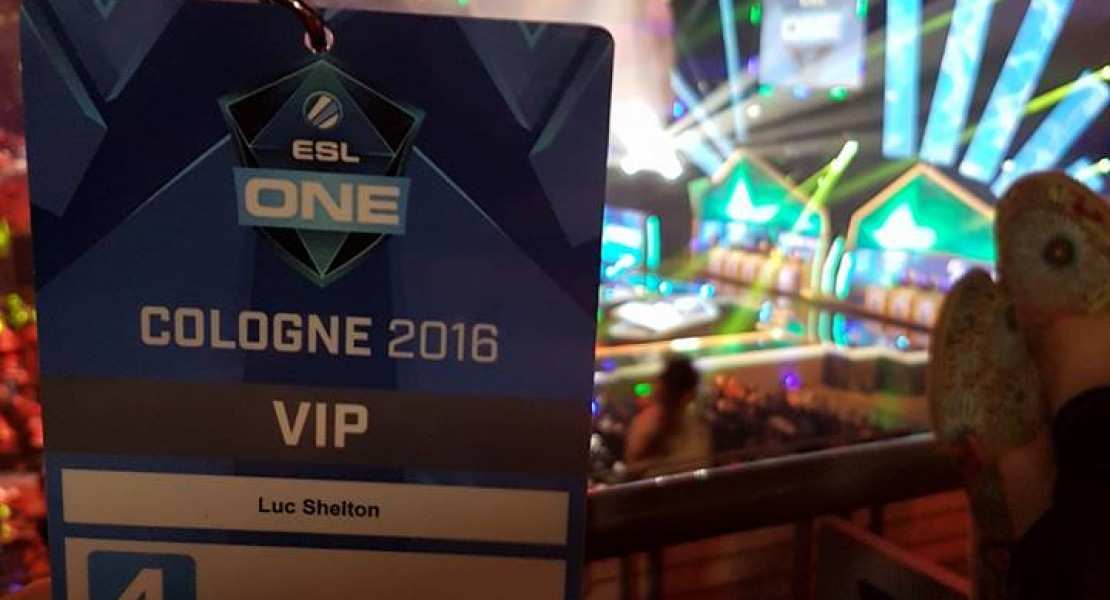 A picture of my VIP entry pass held in front of the stadium while being seated in the far corner of the arena.